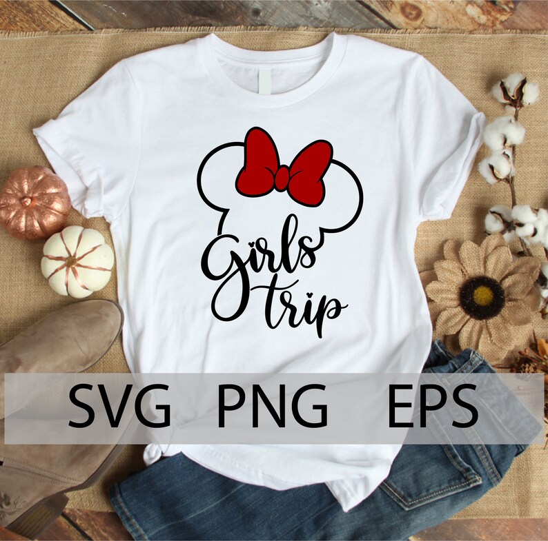 May include: White t-shirt with a black and red graphic design. The graphic features a stylized Mickey Mouse ear silhouette with a red bow and the text "Girls Trip".