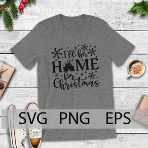 May include: A gray t-shirt with a black graphic that says "I'll be home for Christmas" with a silhouette of a castle in the middle of the word "home".