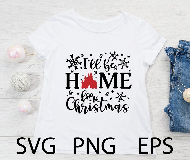 May include: White t-shirt with black text that reads "I'll be home for Christmas" with a red and black castle graphic in the middle. The text is surrounded by black snowflake graphics.