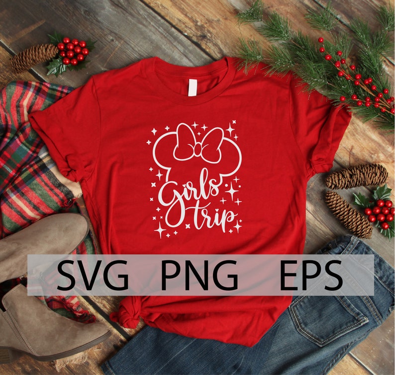 May include: Red t-shirt with a white design of a Mickey Mouse head with a bow and the text "Girls Trip" with white glitter stars.