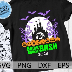 May include: Black t-shirt with a green and orange pumpkin design. The shirt features a silhouette of a castle with bats and a full moon. The text "Boogie Bash 2023" is printed on the shirt.
