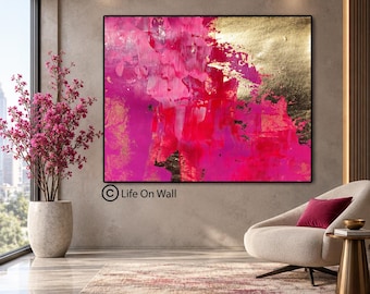 May include: A large rectangular abstract painting featuring vibrant shades of hot pink and magenta blended with textured metallic gold leaf accents. The artwork is framed in a thin black border and displays the text Life On Wall in the lower left corner.