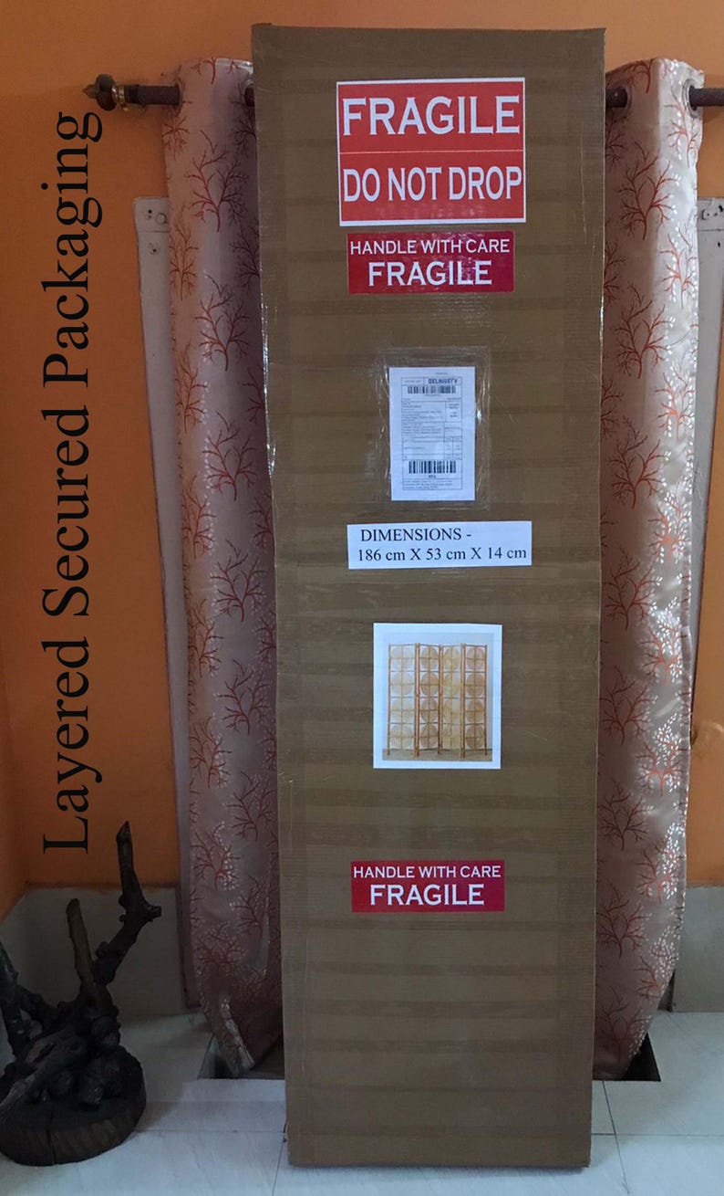 May include: A large, rectangular cardboard package with "FRAGILE" and "HANDLE WITH CARE" labels. Dimensions are 186 cm x 53 cm x 14 cm. The package is sealed and ready for shipping, with a smaller image and shipping label.