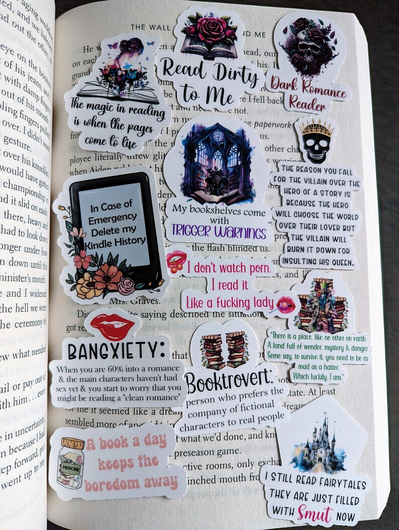 May include: A collection of colorful stickers with various book-themed quotes and illustrations. The stickers feature a dark gothic castle, a skull with a crown, a stack of books, a red lips sticker, a jar of medicine, and a castle with a fairytale theme. The stickers are perfect for decorating journals, laptops, or water bottles.