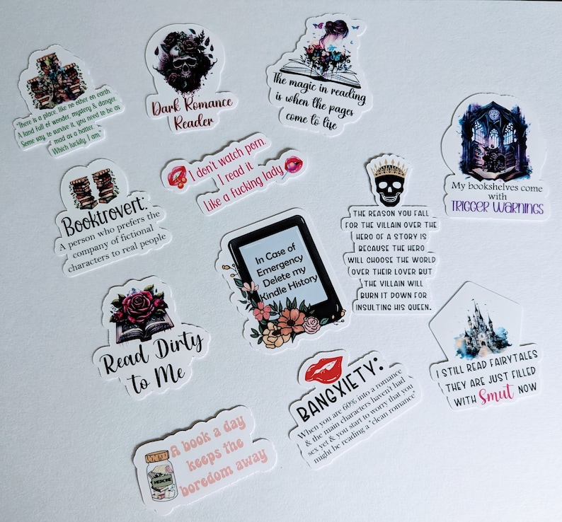 May include: A collection of ten colorful stickers with various book-themed quotes and illustrations. The stickers feature a dark romance reader, a booktrovert, a book a day keeps the boredom away, read dirty to me, in case of emergency delete my kindle history, the reason you fall for the villain over the hero of a story is because the hero will choose the world over their lover but the villain will burn it down for insulting his queen, bangxiety, my bookshelves come with trigger warnings, I still read fairytales they are just filled with smut now, and the magic in reading is when the pages come to life.