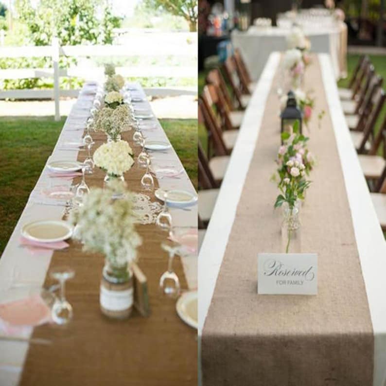 May include: Two wedding tables decorated with burlap table runners. The table on the left has white flowers in glass vases and white plates with pink napkins. The table on the right has a sign that says "Reserved for Family" and a vase of pink flowers.