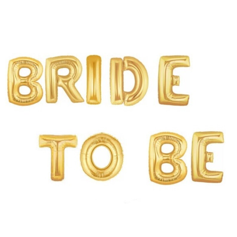May include: Gold foil letter balloons spelling out "BRIDE TO BE".