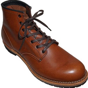 May include: Brown leather work boots with a lace-up closure and a thick rubber sole.