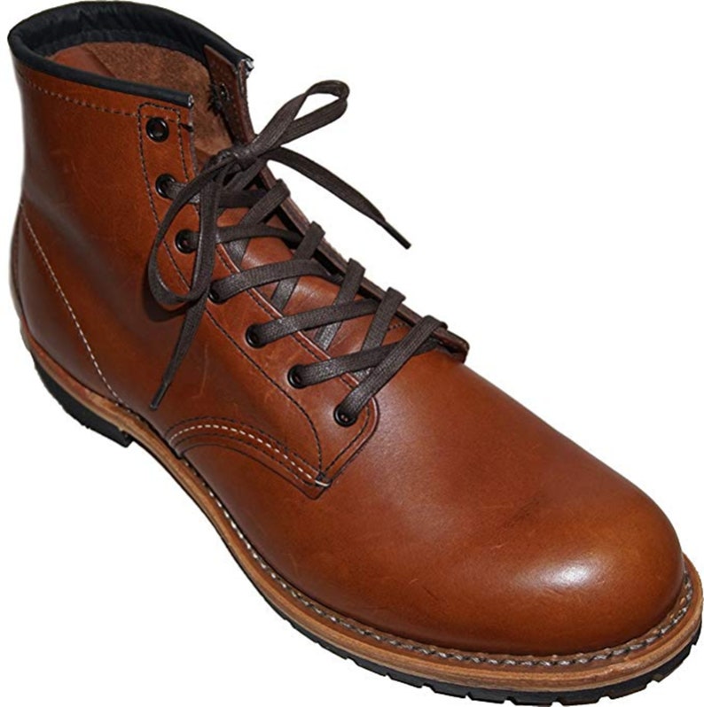 May include: Brown leather work boots with a lace-up closure and a thick rubber sole.