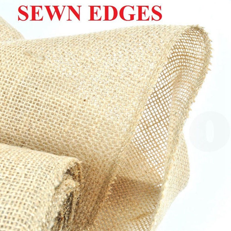 May include: A close-up of natural burlap fabric with sewn edges. The fabric is a light brown color and has a rough texture.