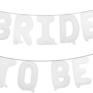 May include: White balloon letters spelling "BRIDE TO BE" hanging on a string. The letters are inflated and ready for a party.