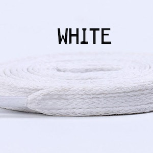 May include: White cotton shoelaces, rolled up and ready to be used. The laces are flat and have a woven texture.