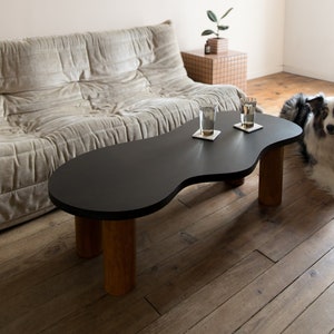 Wooden coffee table with organic shape and pretty curves, two-tone tinted oil finish