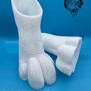 May include: White TPU feetpaws for cosplay or furry costumes. The paws are designed for both plantigrade and digitigrade styles. The text "TPU FEETPAWS PLANTIGRADE & DIGITIGRADE" is printed below the paws. The image also includes a logo for "DIRE CREATURES" in the top right corner.