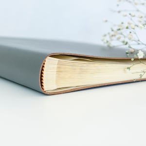 an a4 photo album on its side showing the tail band and the traditional bnding of the photo album