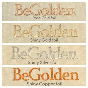 A cream grid has been sliced horizontally into four parts. Each part has the words BeGolden printed on it in a different colour - rose gold, gold, silver and copper.