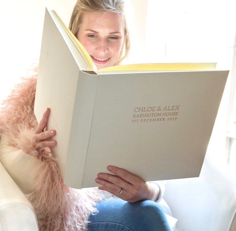 a large, linen, handmade photo album hotfoil embossed with your own words. This ivory linen photo album has been printed with the details of the bride and groom on the front in gold foil