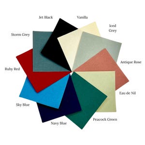 May include: A color palette of fabric swatches arranged in a circular pattern. Colors include Jet Black, Vanilla, Iced Grey, Antique Rose, Eau de Nil, Peacock Green, Navy Blue, Sky Blue, Ruby Red, and Storm Grey. Each swatch has a color name.