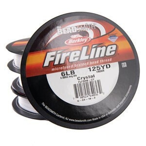 May include: Four spools of white Berkley FireLine braided fishing line. The spools are labeled with the brand name, product name, and specifications: 6lb, 125YD, Crystal.
