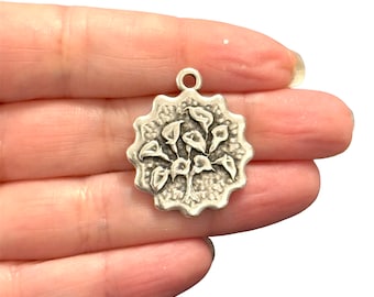 May include: Silver charm featuring a detailed embossed design of a cluster of calla lilies.