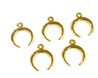 May include: Five gold crescent moon charms with a loop at the top for attaching to jewellery or other crafts.