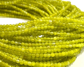 May include: A strand of small, round, light green jade beads. The beads are uniform in size and have a smooth, polished finish.