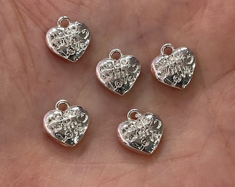 Puede incluir: Cinco dijes de plata en forma de corazón con las palabras "Always and Forever" grabadas.