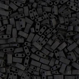 May include: A close-up image of a large pile of black rectangular beads with two holes in each bead. The beads are made of a matte material and have a slightly textured surface.