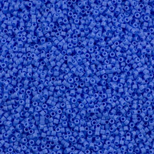 May include: A close-up view of a large quantity of small, round, blue beads. The beads are all the same size and shape, and they are arranged in a random pattern.