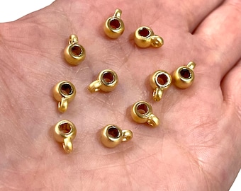 May include: Ten gold-colored metal bead caps with a loop on top. The bead caps are about 1/2 inch in diameter.