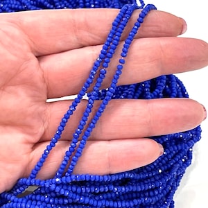 May include: A strand of royal blue faceted glass beads. The beads are small and uniform in size, creating a smooth and elegant look.