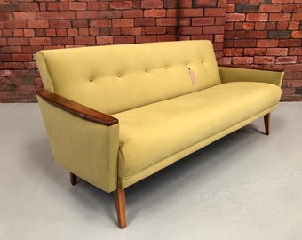 May include: A vintage yellow sofa with wooden arms and legs. The sofa has a tufted design and is in good condition.