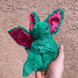 SandiaRare Watermelon Bat Plush – Green Fuzzy Bat with Pink Fruit Print Ears – Handmade Gothic Kawaii Collector Item Stuffed Animal