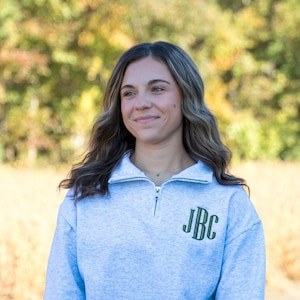 May include: A set of three ceramic mugs with a speckled, matte finish. Each mug features a different color: light blue, cream, and gray. The mugs have a simple, modern design with a rounded shape and a comfortable handle.