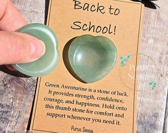 May include: Aventurine thumb stones in a heart and rounded shape. The green stones are next to a card that says "Back to School!" and describes the stone's properties. The card also includes the text "Purus Sensa".