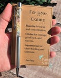 Crystal pen for exams. exam support. good luck. success. genuine natural crystal chips. GCSE A LEVELS. university. black ink ballpoint pen product logo