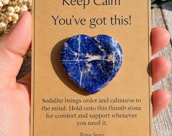 May include: A heart-shaped blue sodalite thumb stone attached to a tan card with the text Keep Calm You've got this! and Sodalite brings order and calmness to the mind. Hold onto this thumb stone for comfort and support whenever you need it. Purus Sensa.