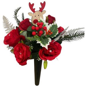 May include: A festive floral arrangement featuring vibrant red roses, holly berries, and decorative silver accents. A wooden reindeer adds a seasonal touch. The arrangement is set in a black vase, perfect for holiday decor.