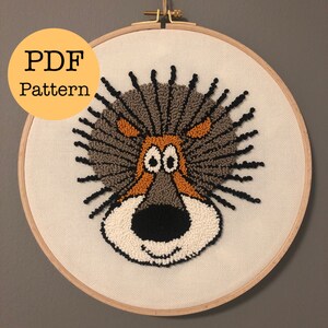 May include: A PDF pattern for a punch needle embroidery project featuring a lion's face with a brown, black, and white colour scheme.