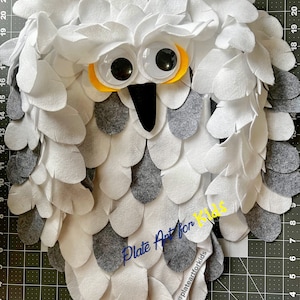 May include: A white and gray felt owl craft project with googly eyes and the text "Plate Art for Kids" and the social media handle "@plateartforkids".