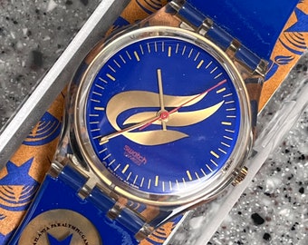 Vintage Swatch Watch 35mm Blue and Gold called Starfire 1995 in box RARE with original strap and paperwork with battery running well