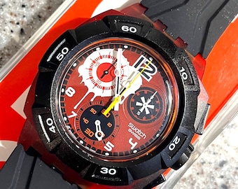 Seltene Swatch Uhr Quartz Reddish Black Quartz analog grösseres Ziffernblatt 39 mm brandneu in Box ungetragen mit Batterie
