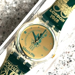 NUEVO Reloj Swatch Vintage 1996 Olympics watch Atlanta nunca usado con batería en caja GZ136 verde y dorado 34 mm swatch
