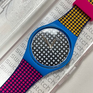 Reloj Swatch maravillosamente brillante, nuevo, sin usar, en su caja con batería, esfera de 34 mm, modelo Behind the Wall, correa de silicona para uso diario.
