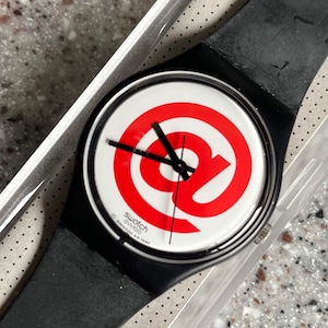 Vintage Never Worn Swatch Watch 96 in box with battery part of a series called Sign it is an ampersand or “at” sign 34mm RARE original