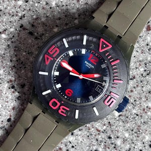 Vintage Swatch Watch Never Worn in original box with battery called WHALEBONE original swatch with blue dial green silicone strap great