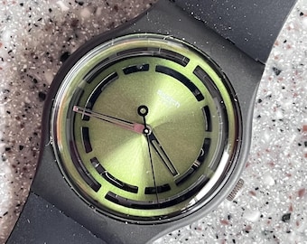 NEW larger face 41mm Swatch watch called LEAFY Line brand new in box unworn great bioceramic with a flexible band fun perforations GREEN