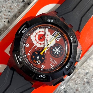 Rare Swatch Watch Chronograph Reddish Black quartz analog larger face of 39mm brand new in box never worn old stock with battery