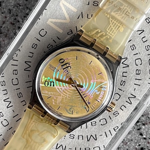 Vintage Swatch Watch Musicall with battery early 90s. SLM101 Spartito unworn NEW original band with 34mm face gold and black with battery
