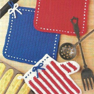 May include: A collection of handmade crochet kitchen items in red, white, and blue. Includes a red square potholder, a blue square potholder, and a red and white striped oven mitt. The potholders and mitt have white trim and bows.